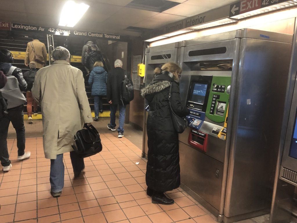 Commuters queuing at Grand Central subway kiosks during morning rush